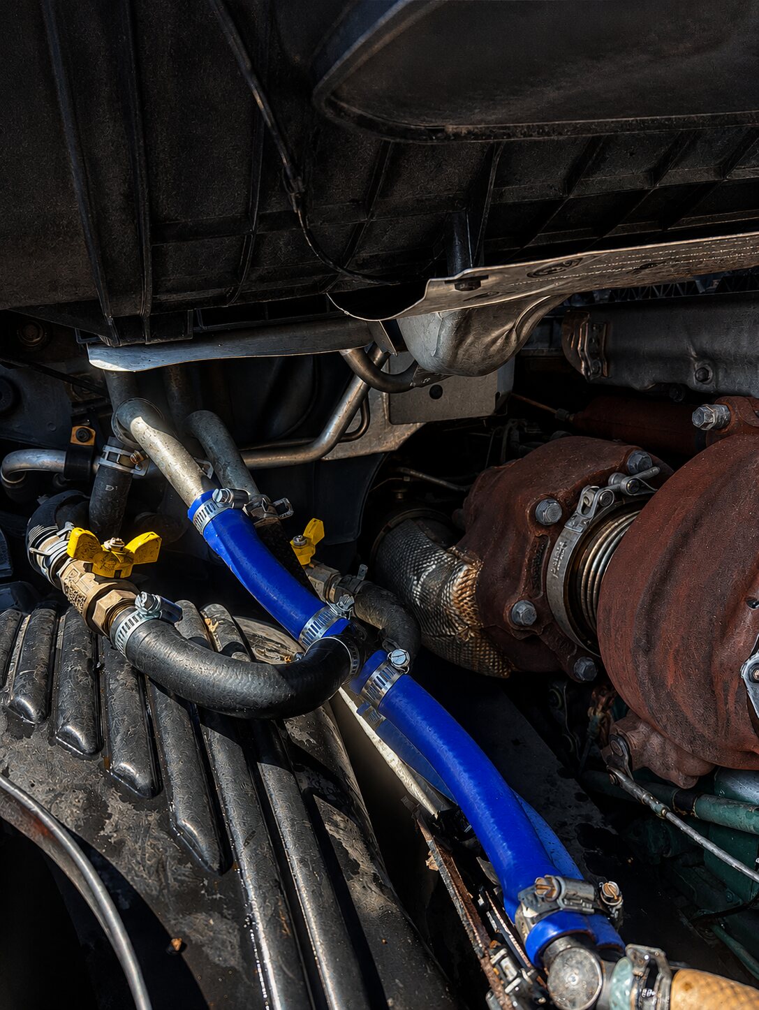 New blue silicone coolant hoses installed on the semi-truck